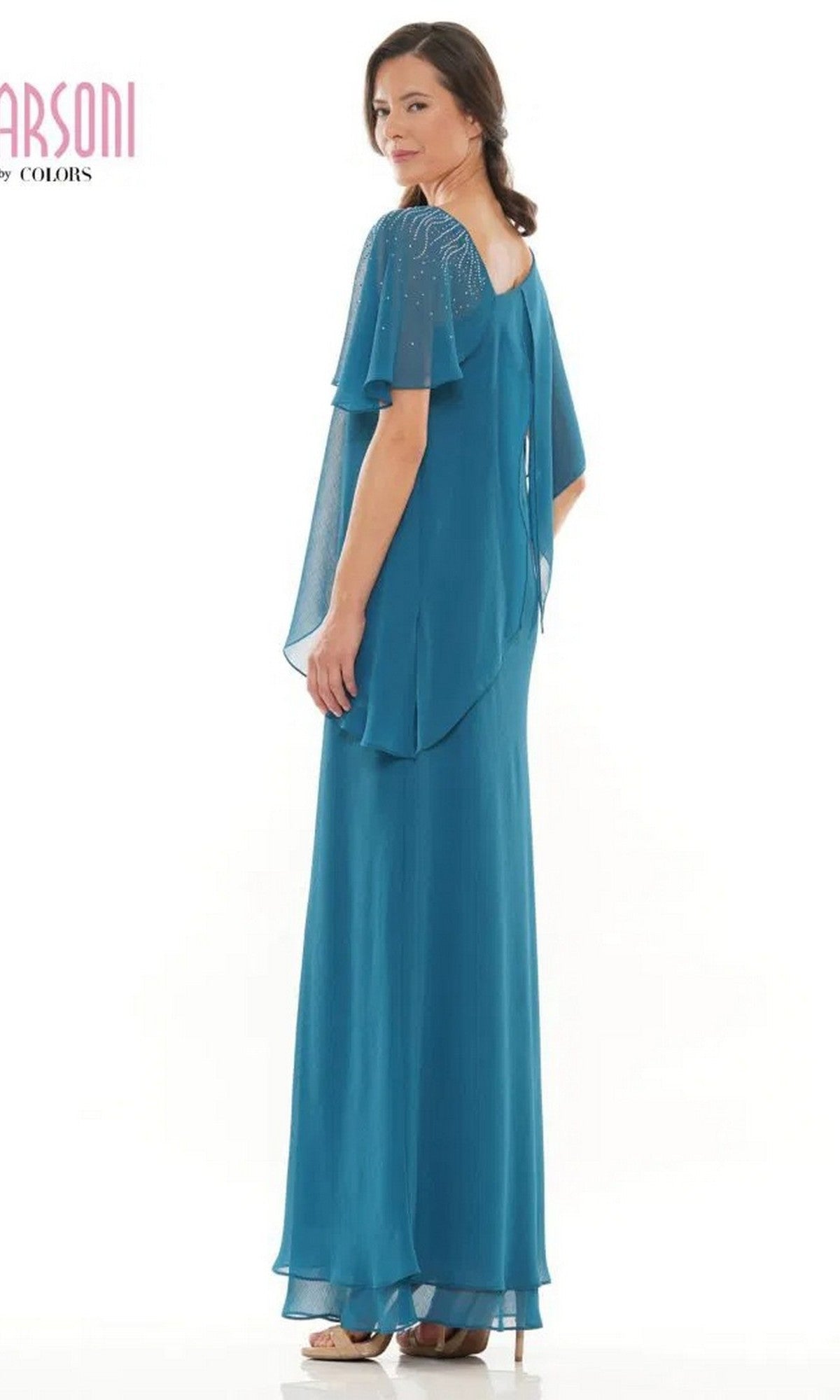 A woman stands slightly turned from the camera in a Marsoni M313 long teal chiffon formal dress with sheer flutter sleeves and beaded accents, set against a white background.